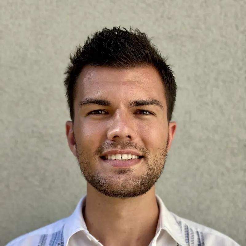 Headshot of Justin Huwe smiling with a blank background
