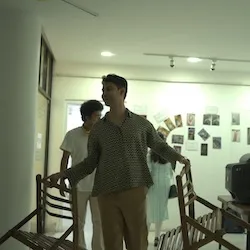 Image of Rishav smiling and holding chairs